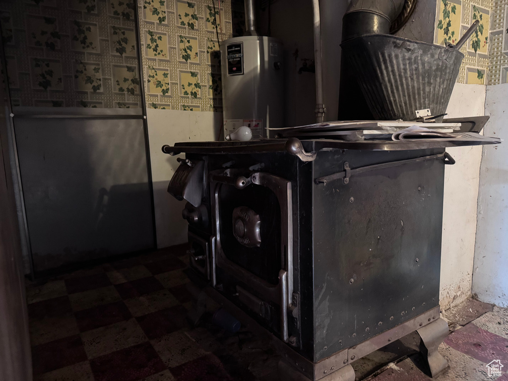 Detailed view of gas water heater and tile patterned floors