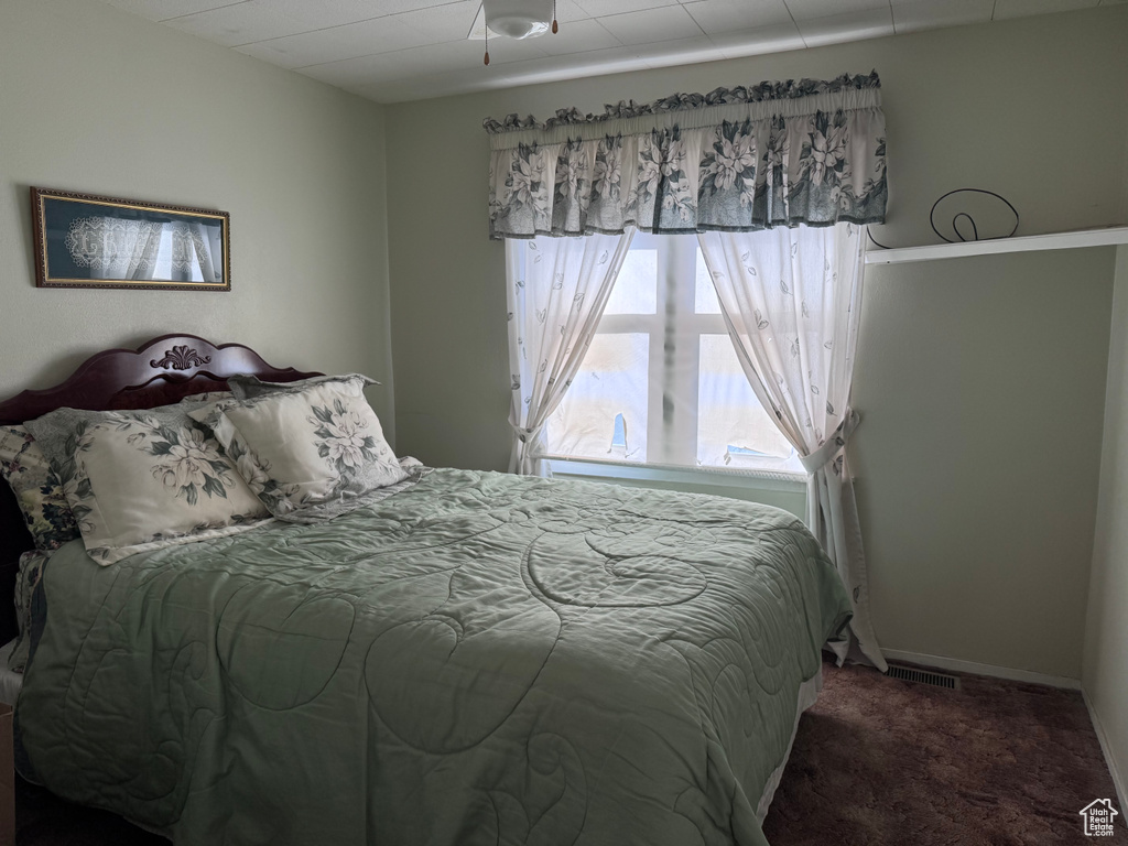 Bedroom with carpet floors and baseboards