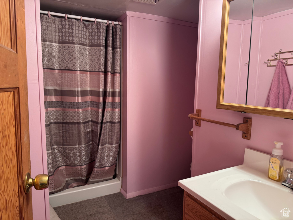Bathroom featuring vanity and a shower with curtain