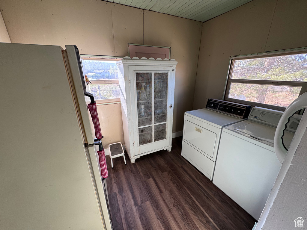 Laundry area with washing machine and clothes dryer, dark wood-style floors, and wood ceiling