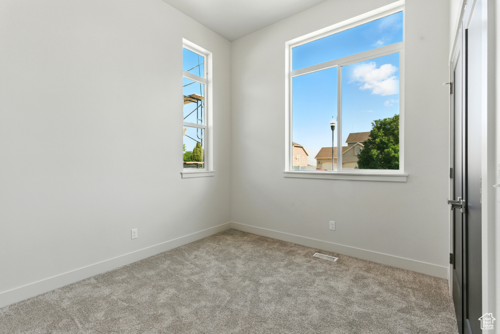 Unfurnished room with carpet and baseboards