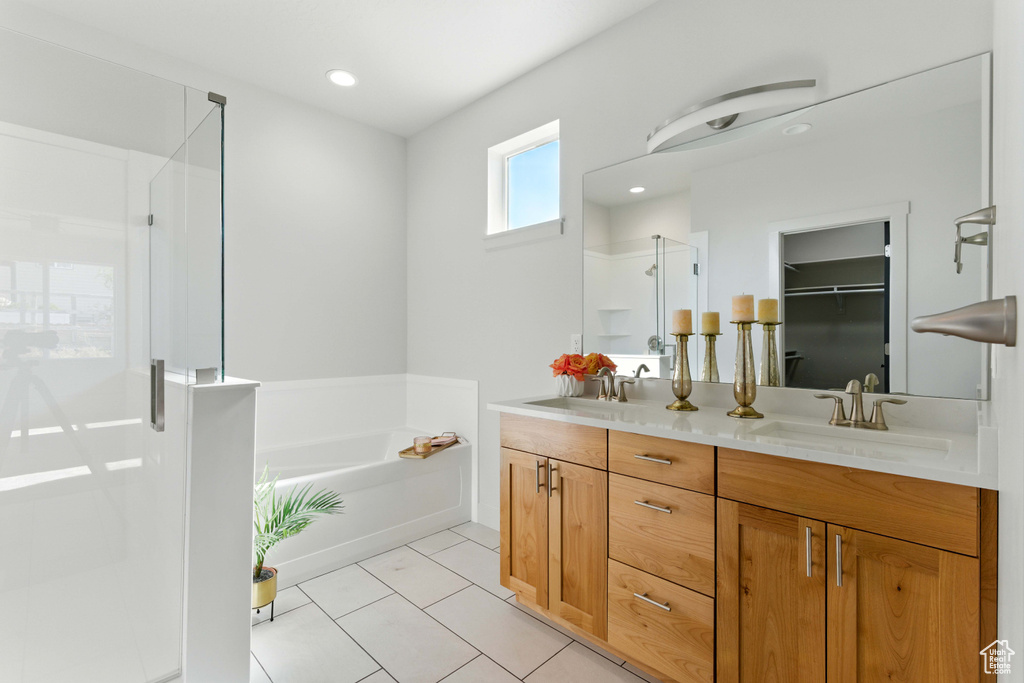 Full bathroom with a shower stall, double vanity, a bath, tile patterned flooring, and recessed lighting