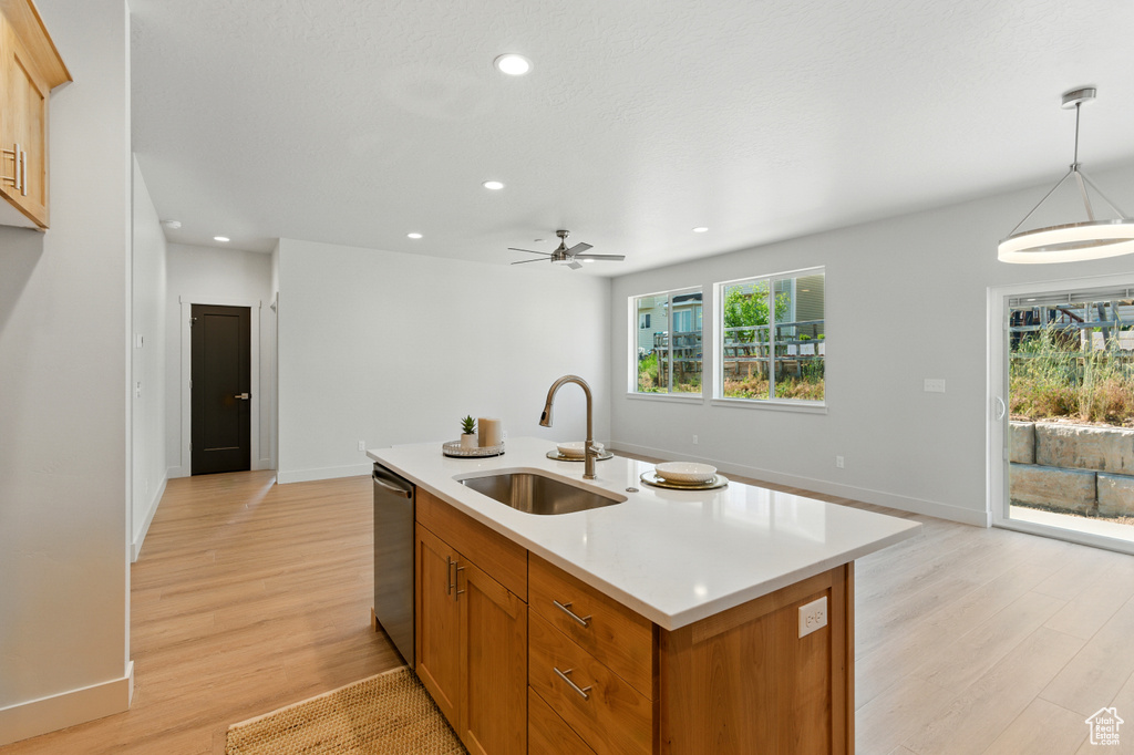 Kitchen featuring light countertops, stainless steel dishwasher, ceiling fan, light wood finished floors, and recessed lighting