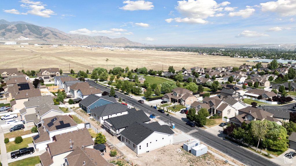 Aerial view of property's location with nearby suburban area and a mountainous background