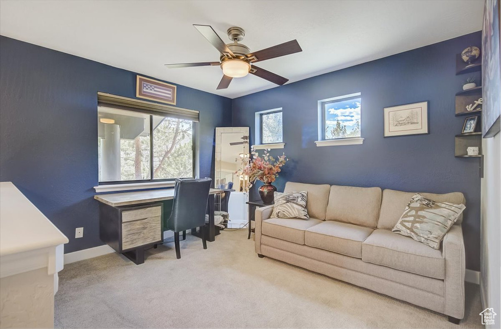 Office with ceiling fan and carpet flooring