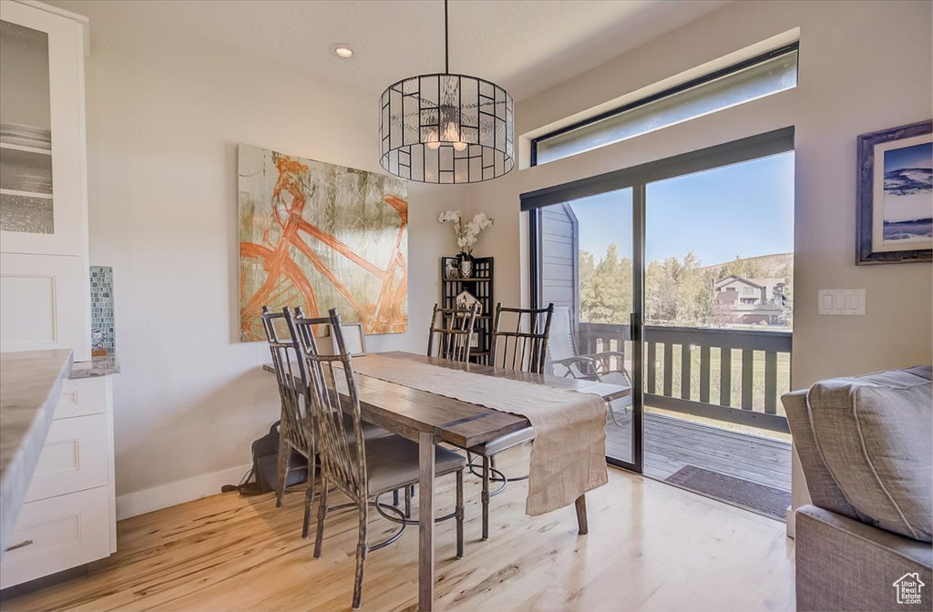 Dining room featuring light wood-style floors, a chandelier, and recessed lighting