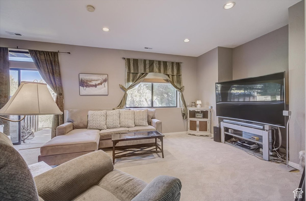 Living area with healthy amount of natural light, carpet, and recessed lighting
