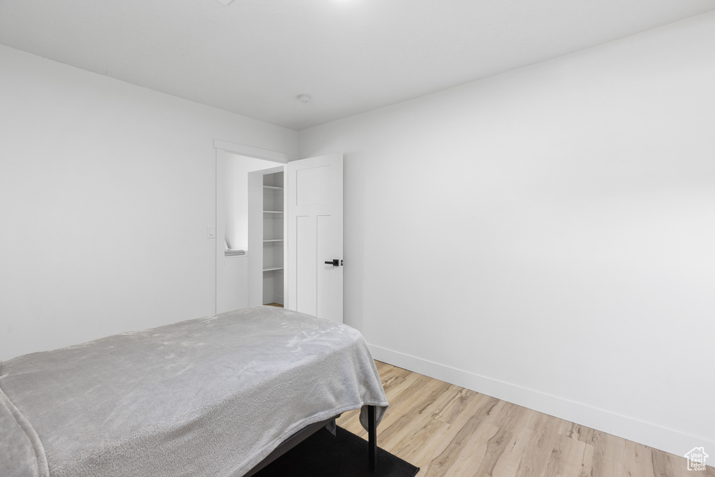 Bedroom with light wood-style flooring and baseboards