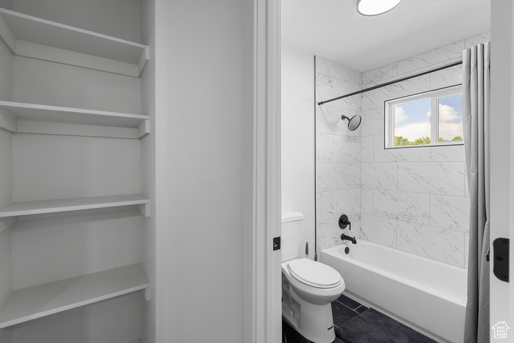 Full bath featuring bathing tub / shower combination and tile patterned flooring