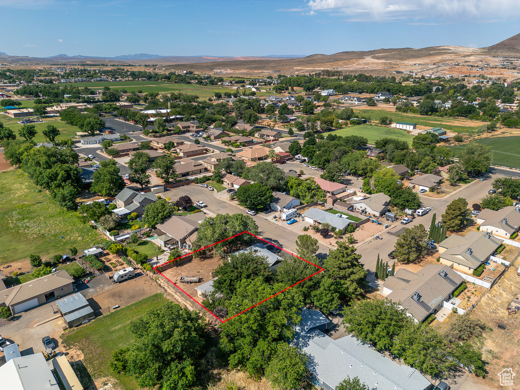 Aerial perspective of suburban area featuring mountains and property boundaries highlighted