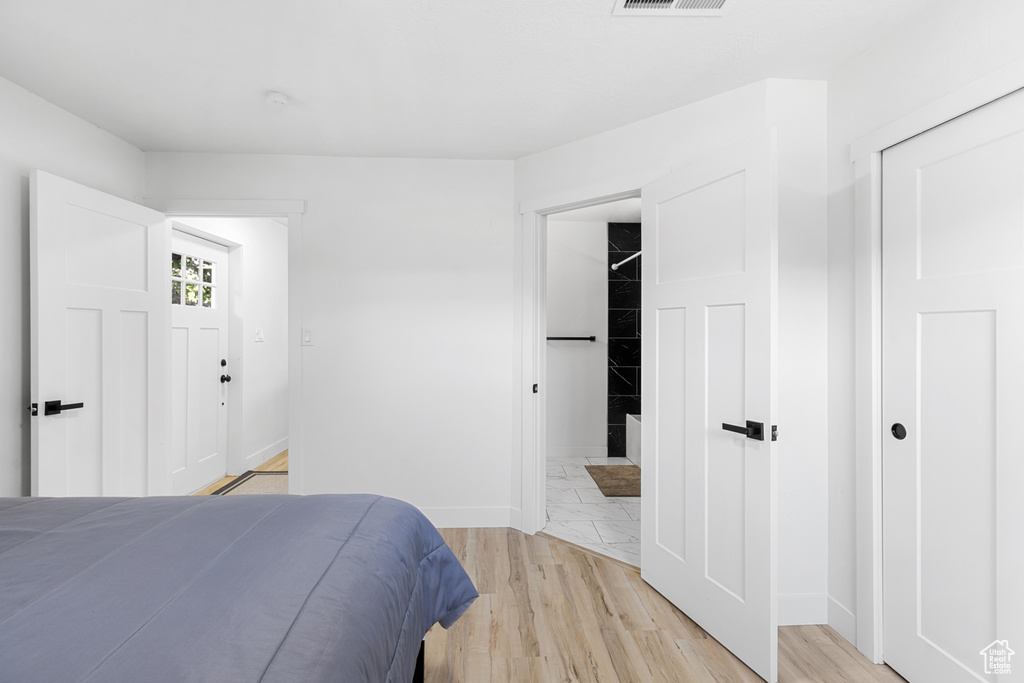 Bedroom featuring baseboards and light wood-style flooring
