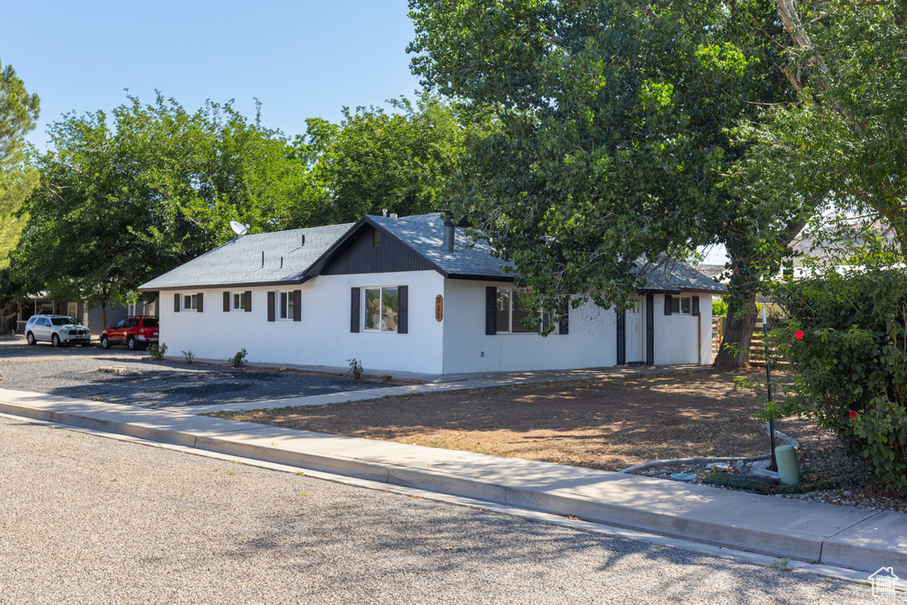 Ranch-style home with roof with shingles