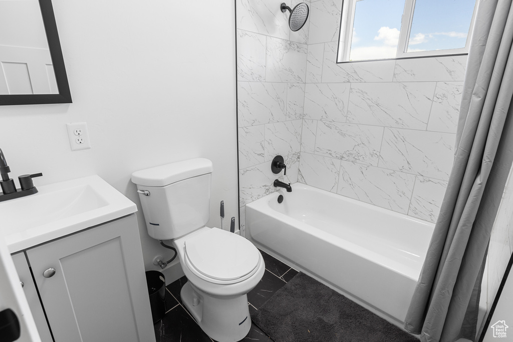 Bathroom with shower / bathtub combination with curtain and vanity