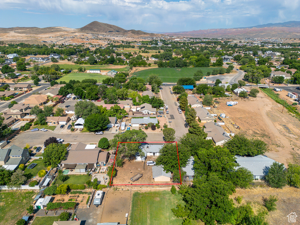 Aerial view of residential area featuring property parcel outlined and a mountainous background