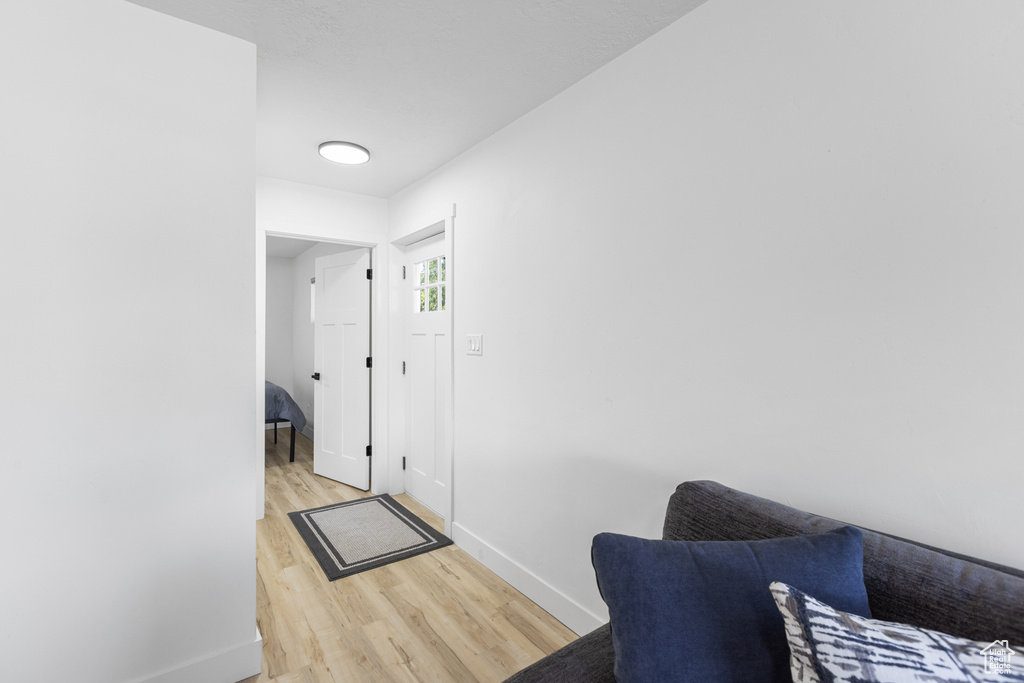 Living area featuring light wood-style floors and baseboards