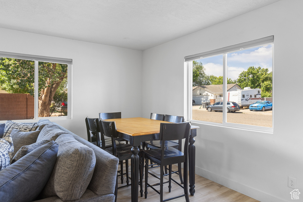 Dining area featuring plenty of natural light and wood finished floors