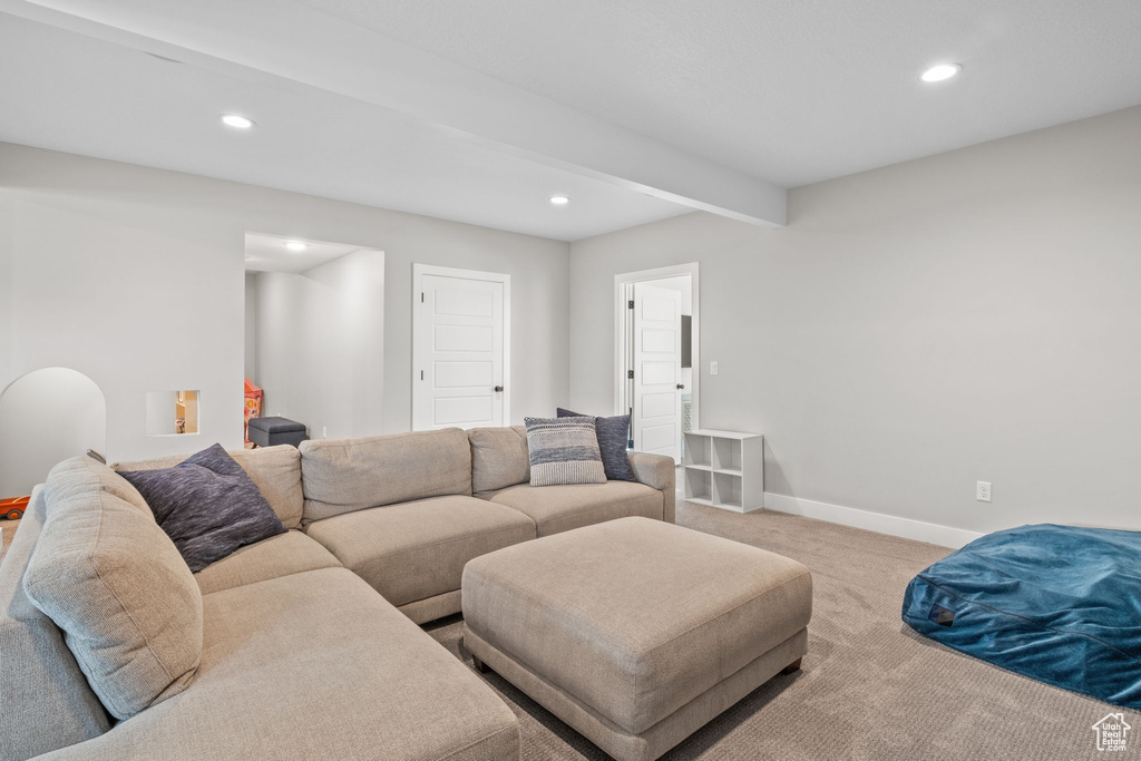 Carpeted living room featuring recessed lighting and beamed ceiling