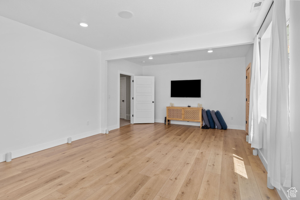 Unfurnished living room with light wood finished floors and recessed lighting