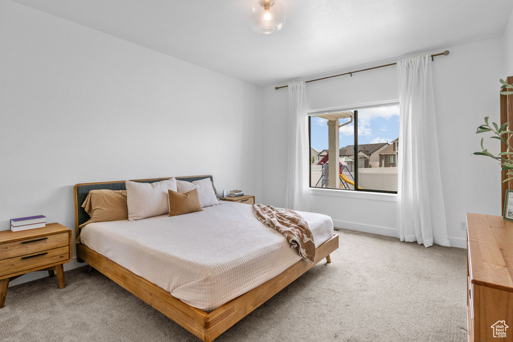 Bedroom with light colored carpet
