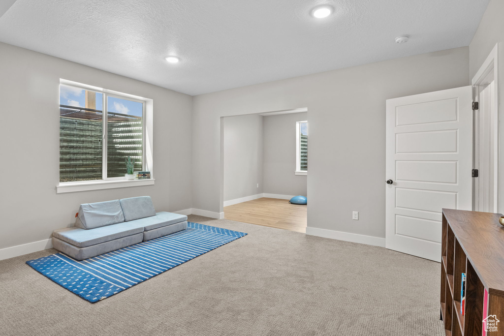 Unfurnished room featuring healthy amount of natural light, carpet flooring, and recessed lighting