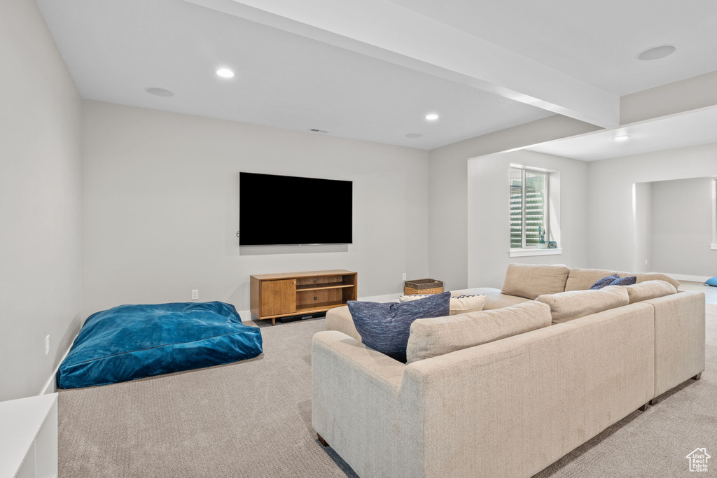 Living area featuring light colored carpet and recessed lighting