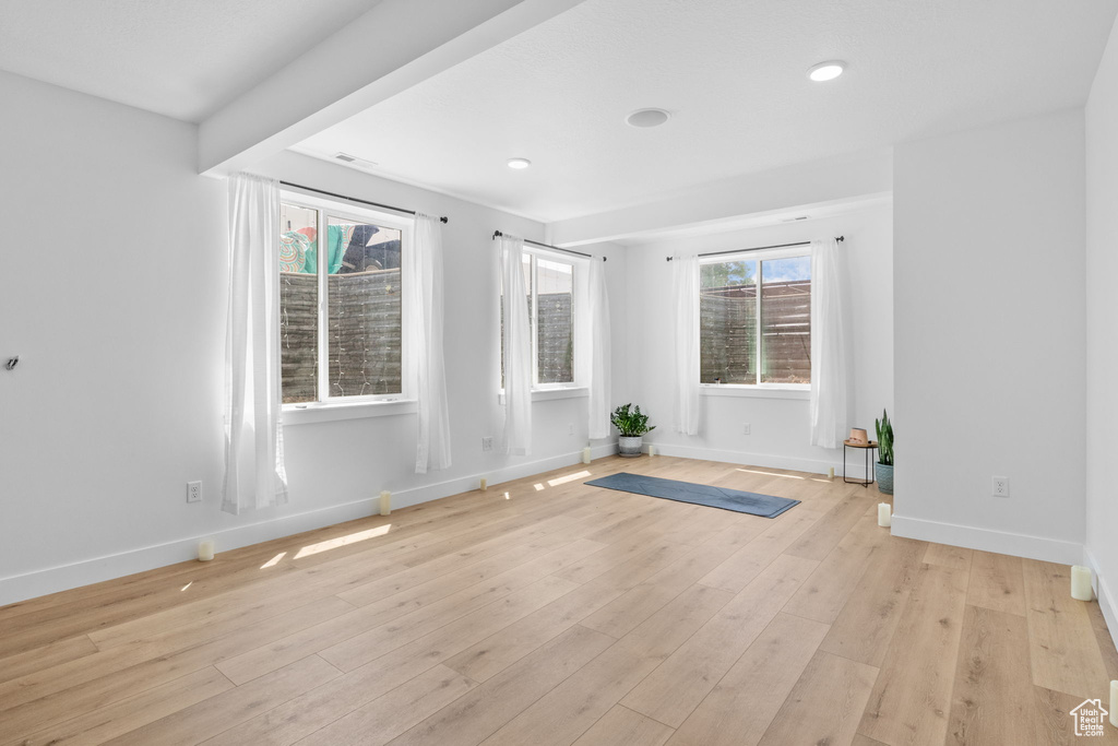 Spare room featuring light wood finished floors and recessed lighting