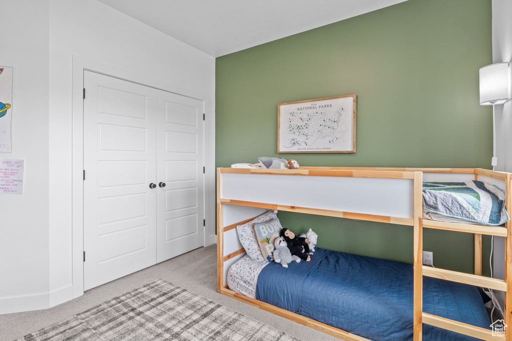 Bedroom with carpet and a closet
