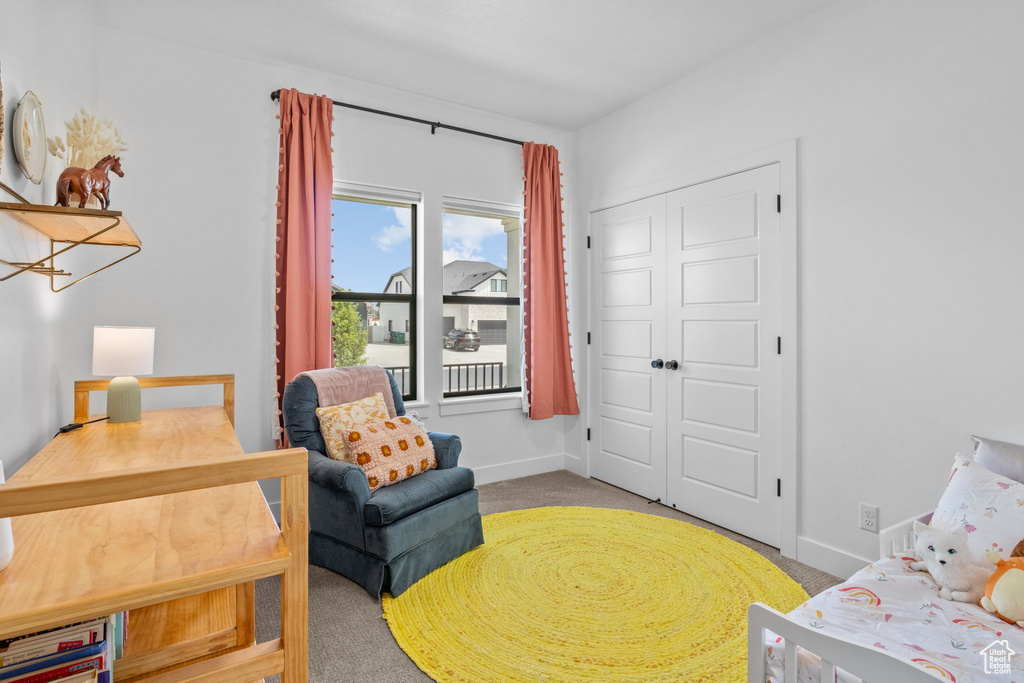 Carpeted bedroom with baseboards and a closet