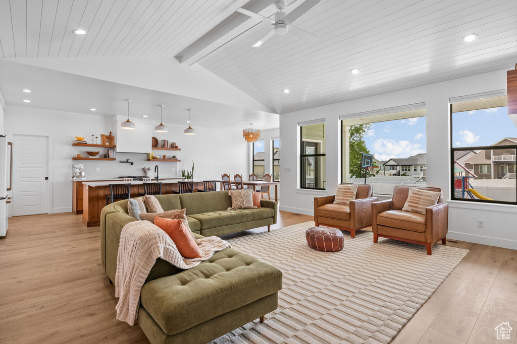 Living room with recessed lighting, light wood-style flooring, ceiling fan, and wood ceiling