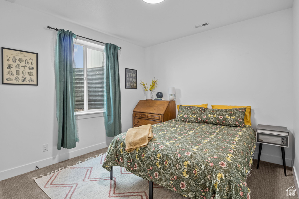 Carpeted bedroom featuring baseboards