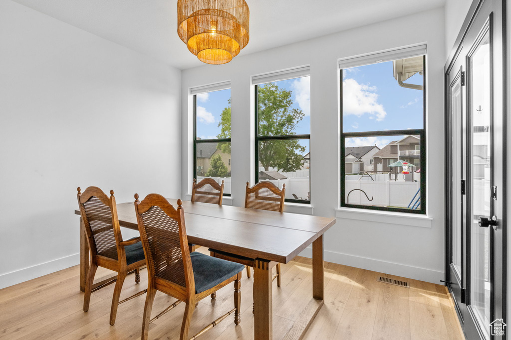 Dining area with baseboards and light wood-type flooring