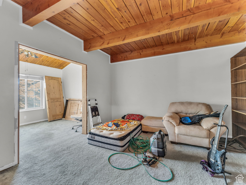 Living room featuring a wooden ceiling with exposed beams and carpet flooring