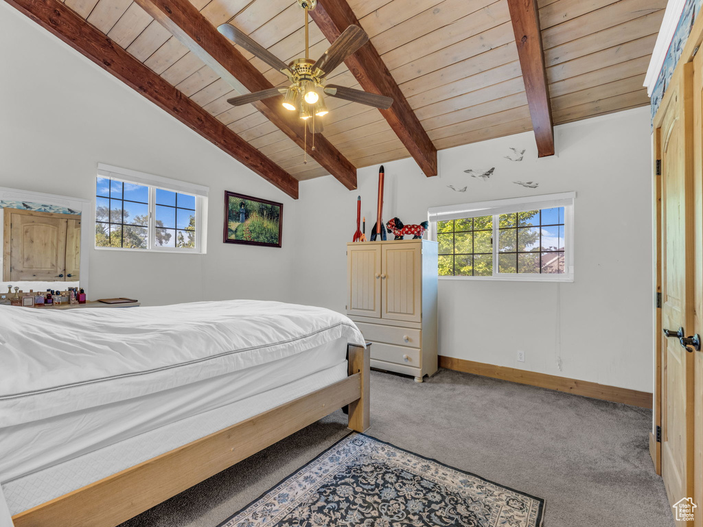 Bedroom with wood ceiling and light colored carpet