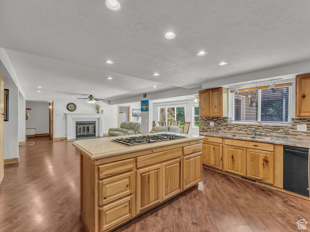 Kitchen featuring stainless steel gas stovetop, decorative backsplash, dark wood-style flooring, and recessed lighting