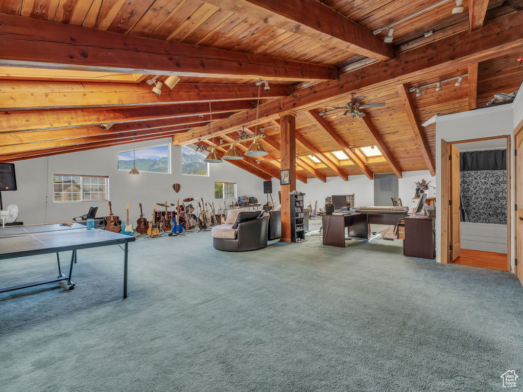 Recreation room with wood ceiling, carpet flooring, and a ceiling fan