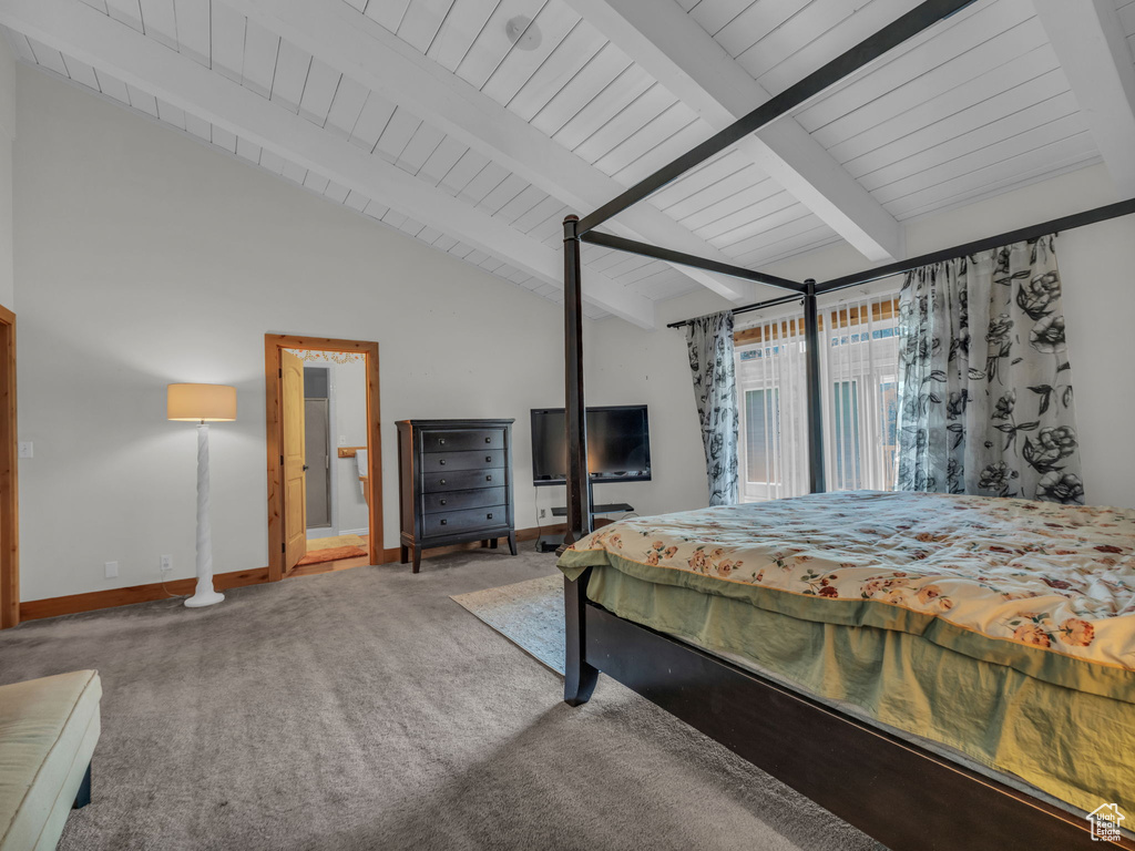 Carpeted bedroom featuring baseboards and wood ceiling