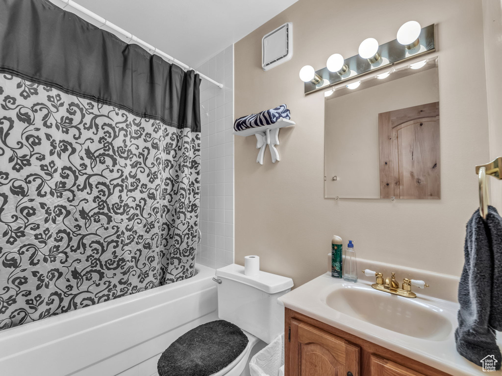 Bathroom featuring vanity and shower / bath combo