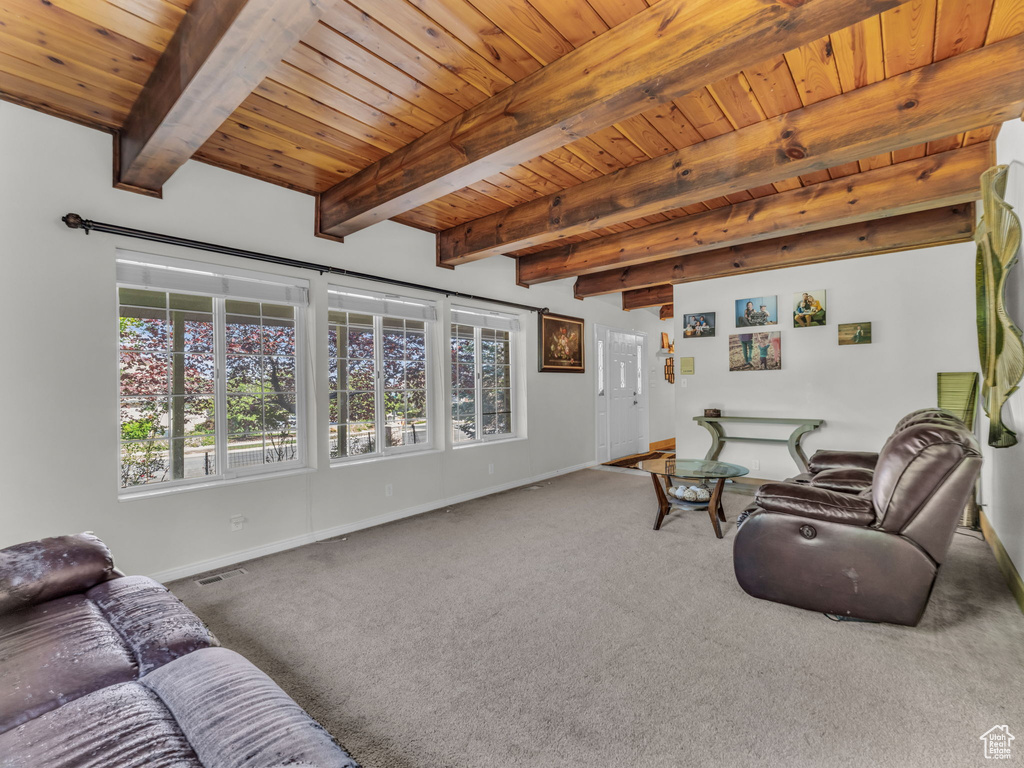 Living room with carpet and a wooden ceiling with exposed beams