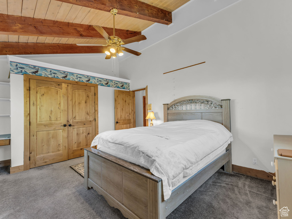 Carpeted bedroom featuring wood ceiling and a ceiling fan