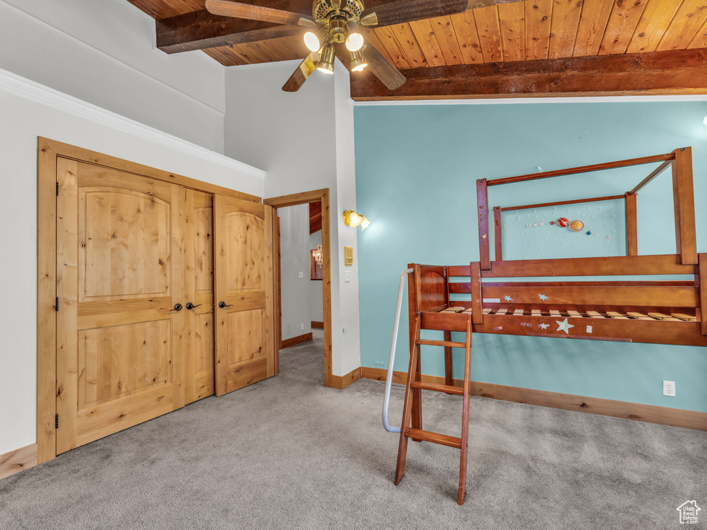 Bedroom with wood ceiling and carpet floors