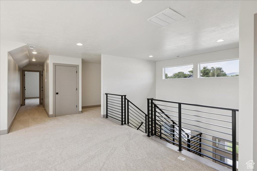 Carpeted empty room with recessed lighting and baseboards