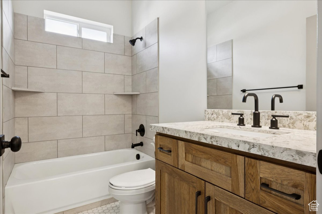 Full bath with vanity, bathtub / shower combination, and tile patterned floors