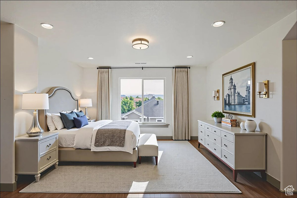 Bedroom with dark wood-style floors and recessed lighting