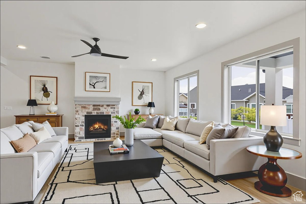 Living area featuring ceiling fan, light wood finished floors, a brick fireplace, and recessed lighting