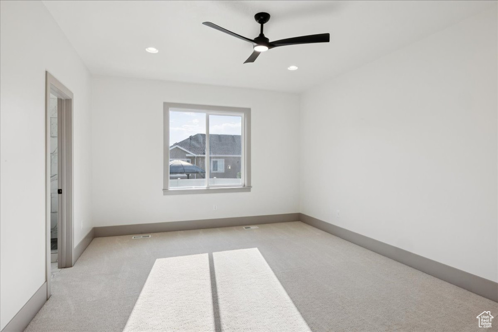 Spare room featuring carpet floors, a ceiling fan, and recessed lighting