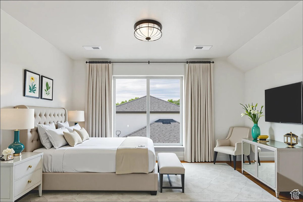 Bedroom featuring lofted ceiling