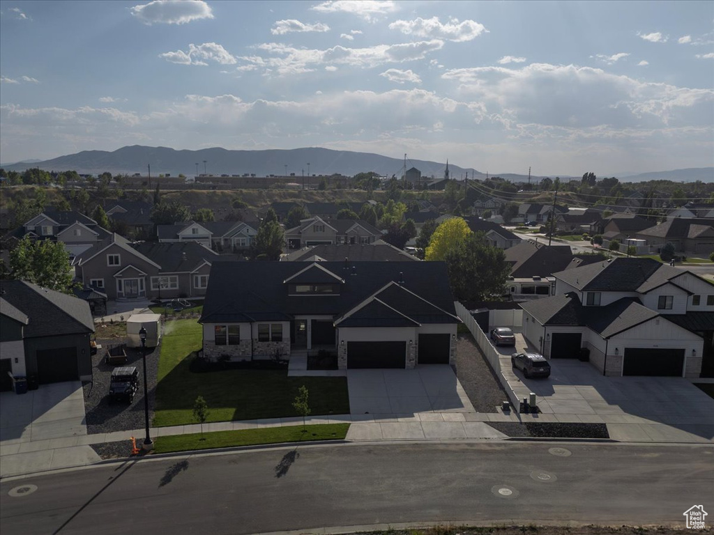 Aerial view of residential area featuring a mountainous background