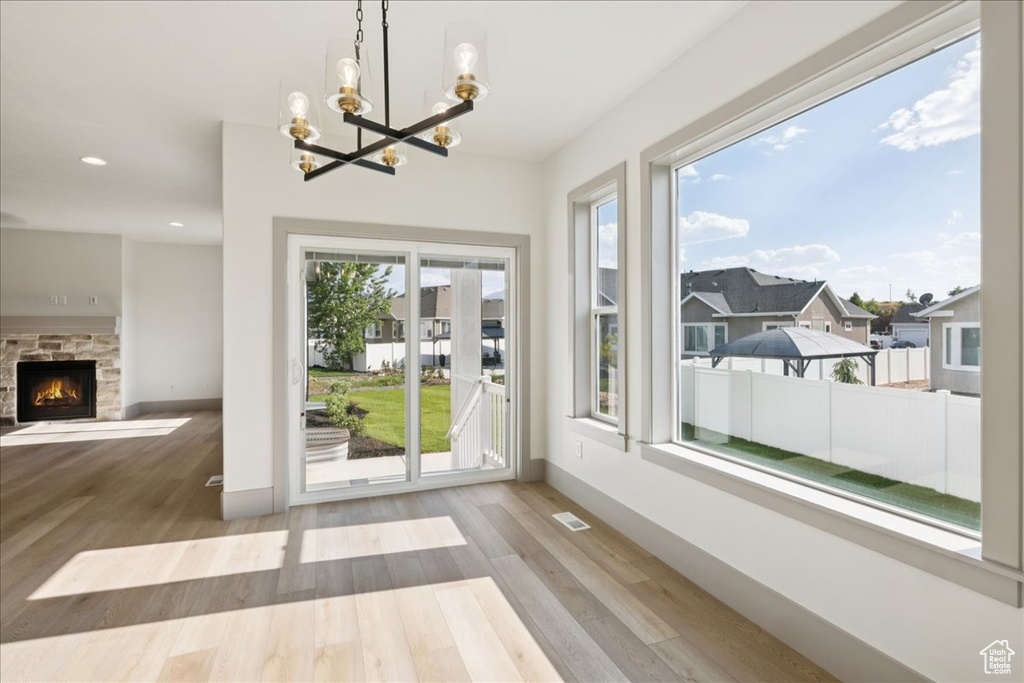 Unfurnished sunroom with a chandelier