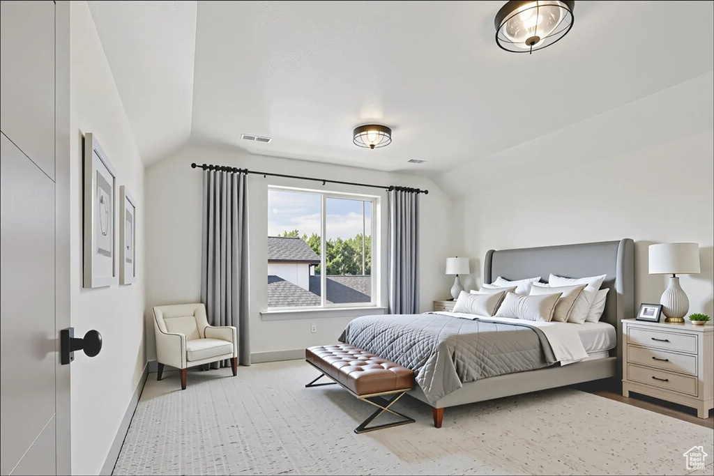 Bedroom featuring lofted ceiling