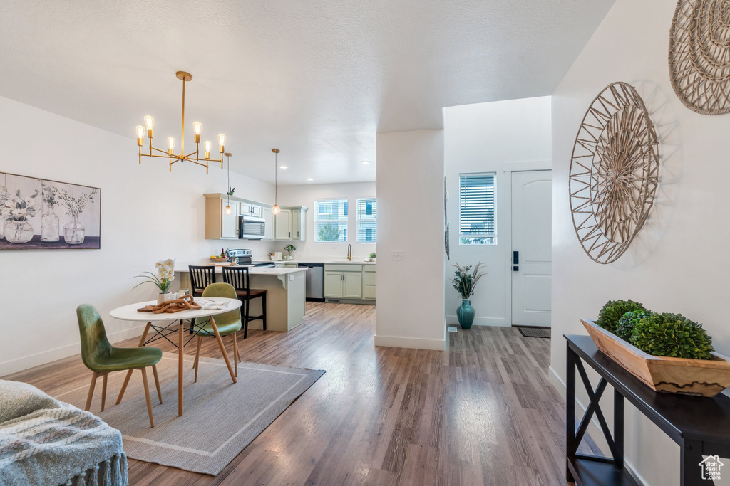 Foyer entrance featuring a chandelier and light wood-style floors